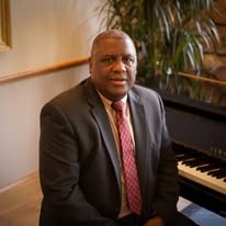 Roy Hanner seated at a piano